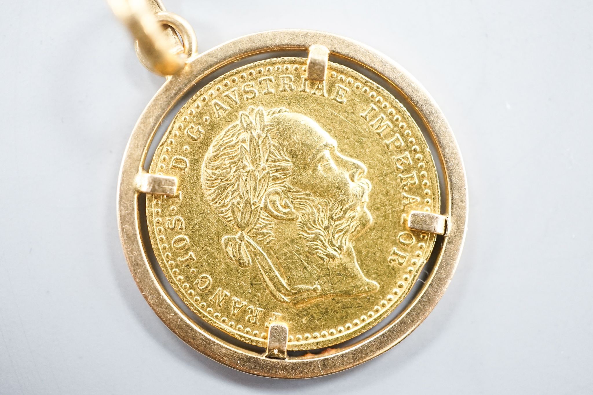 An Austrian 1915 gold ducat re-strike?, on a 750 yellow metal pendant mount, gross 6.2 grams.